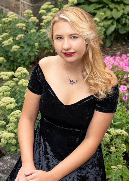 A flower garden serves as the setting for this senior portrait by State College portrait photographer Rusty Glessner