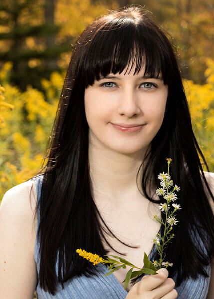A senior portrait in a field of goldenrod by State College portrait Photographer Rusty Glessner
