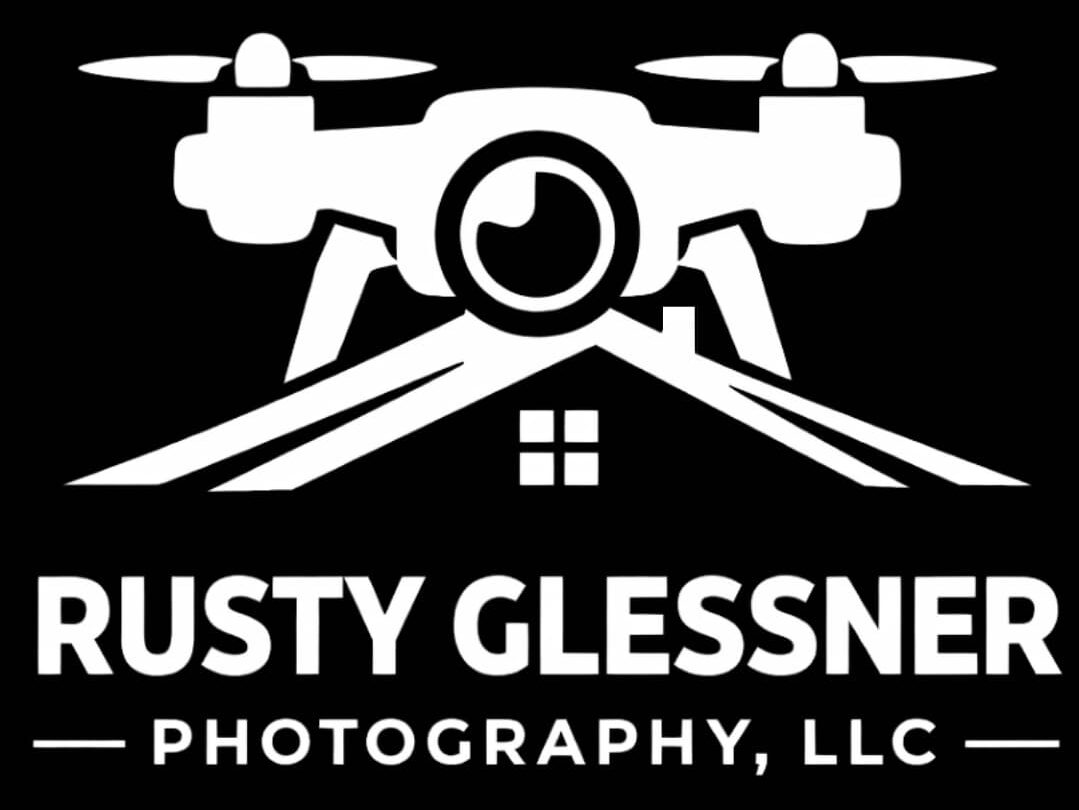 Drone with camera hovering above a rooftop graphic above the text Rusty Glessner Photography, LLC logo representing aerial photography services.